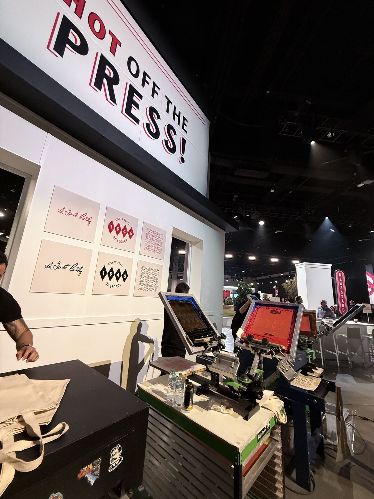 Overhead view of an event booth setup showing stacked merchandise and an organized product display